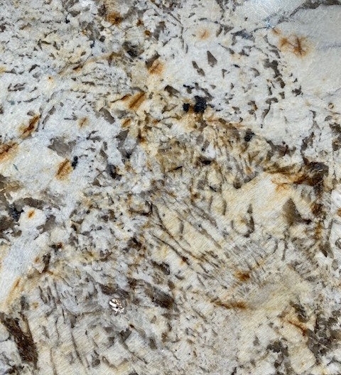 Marmo Maculato Bronzato - This natural granite delivers an eye pleasing collection of gentle wisping features including black stippling on a greige and copper tone background.