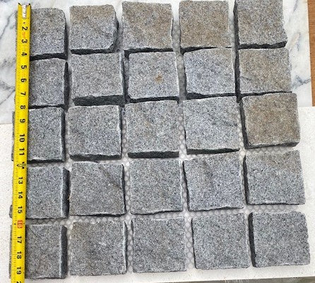 Stormy Granite Cobblestone Pavers - Ideal for driveways, paths and courtyards, these natural surface granite cobbles are non-slip and durable, visit any European city and you will find pavers of a similar material and construction serving their purpose for hundreds of years! Mounted on a plastic mesh for accelerated installation, great for dry or wet setting.