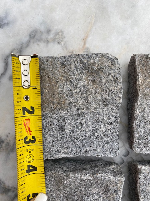 Stormy Granite Cobblestone Pavers - Ideal for driveways, paths and courtyards, these natural surface granite cobbles are non-slip and durable, visit any European city and you will find pavers of a similar material and construction serving their purpose for hundreds of years! Mounted on a plastic mesh for accelerated installation, great for dry or wet setting.
