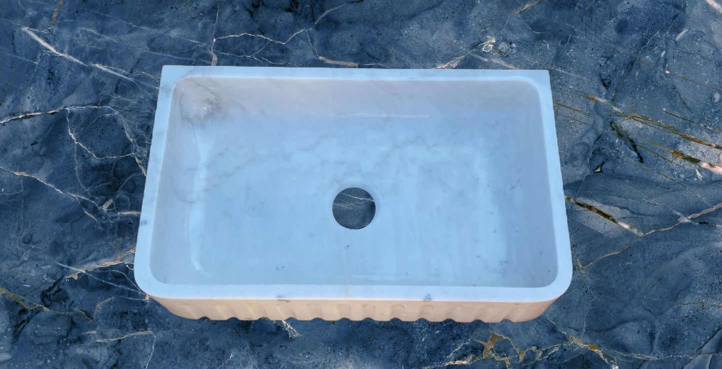 Marble Farmhouse Sink: This beautiful sink is carved from one piece of marble. It features the classic farmhouse style and will last generations!