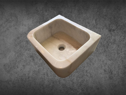 Small Marble Sink: This small white marble sink is carved out from one marble piece and features gray veining. It's perfect for a bathroom or other small space area.