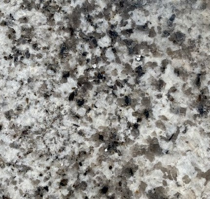 Spanish Gota Negra - Delivering patterns reminiscent of abstract Spanish mosaics, this granite features a white background sprinkled with black and gray.