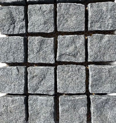 Stormy Granite Cobblestone Pavers - Ideal for driveways, paths and courtyards, these natural surface granite cobbles are non-slip and durable, visit any European city and you will find pavers of a similar material and construction serving their purpose for hundreds of years! Mounted on a plastic mesh for accelerated installation, great for dry or wet setting.